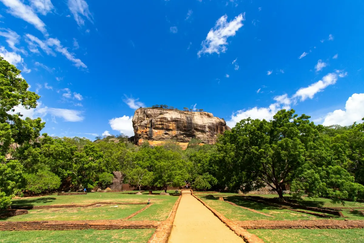 The path towards Sigiriya Rock Fortress under a blue sky in Sri Lanka