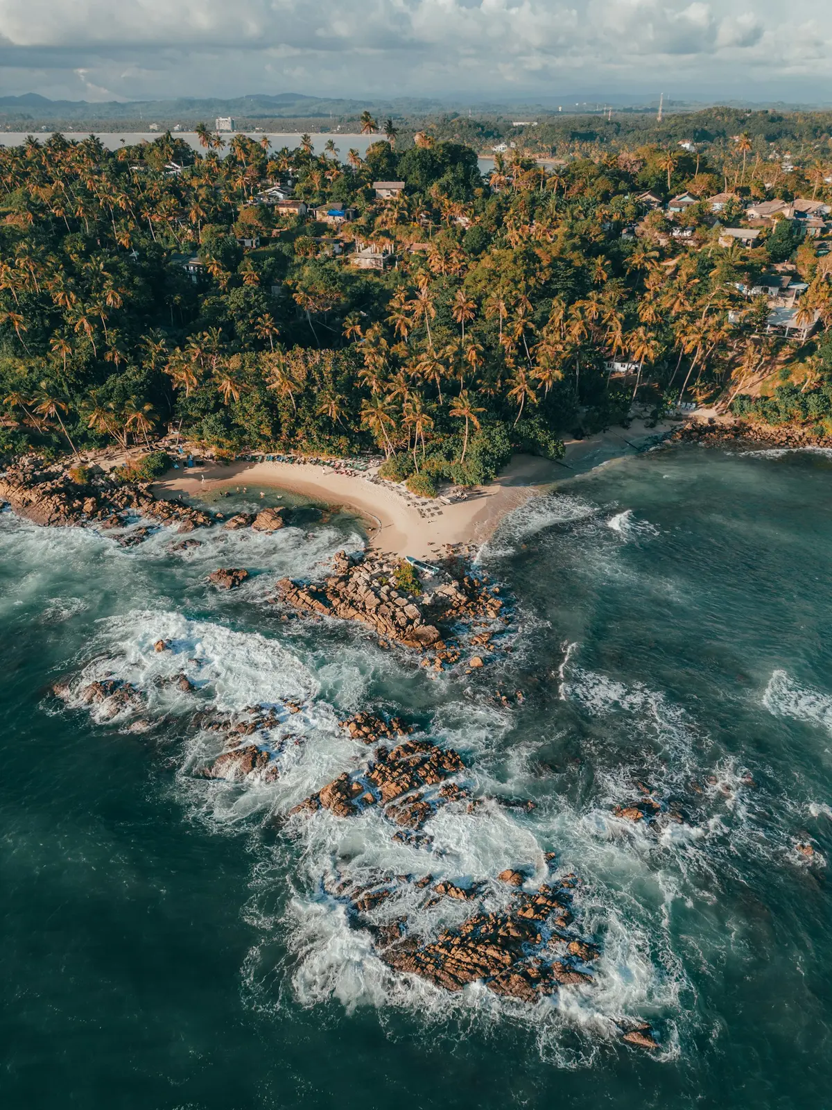 Aerial view of a quiet cove and turquoise sea on the south coast of Sri Lanka